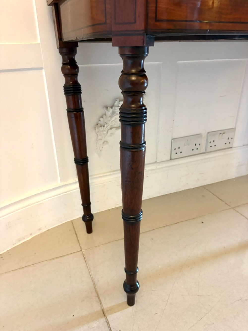 An antique Georgian mahogany fold-over card table featuring turned legs and subtle inlay stringing. View VII