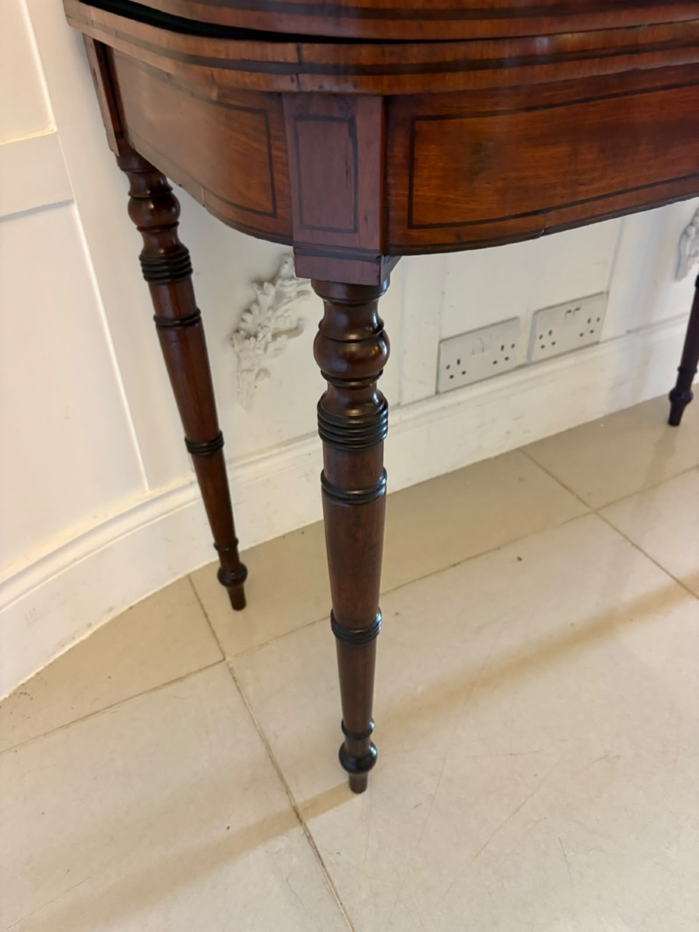 An antique Georgian mahogany fold-over card table featuring turned legs and subtle inlay stringing. View VIII