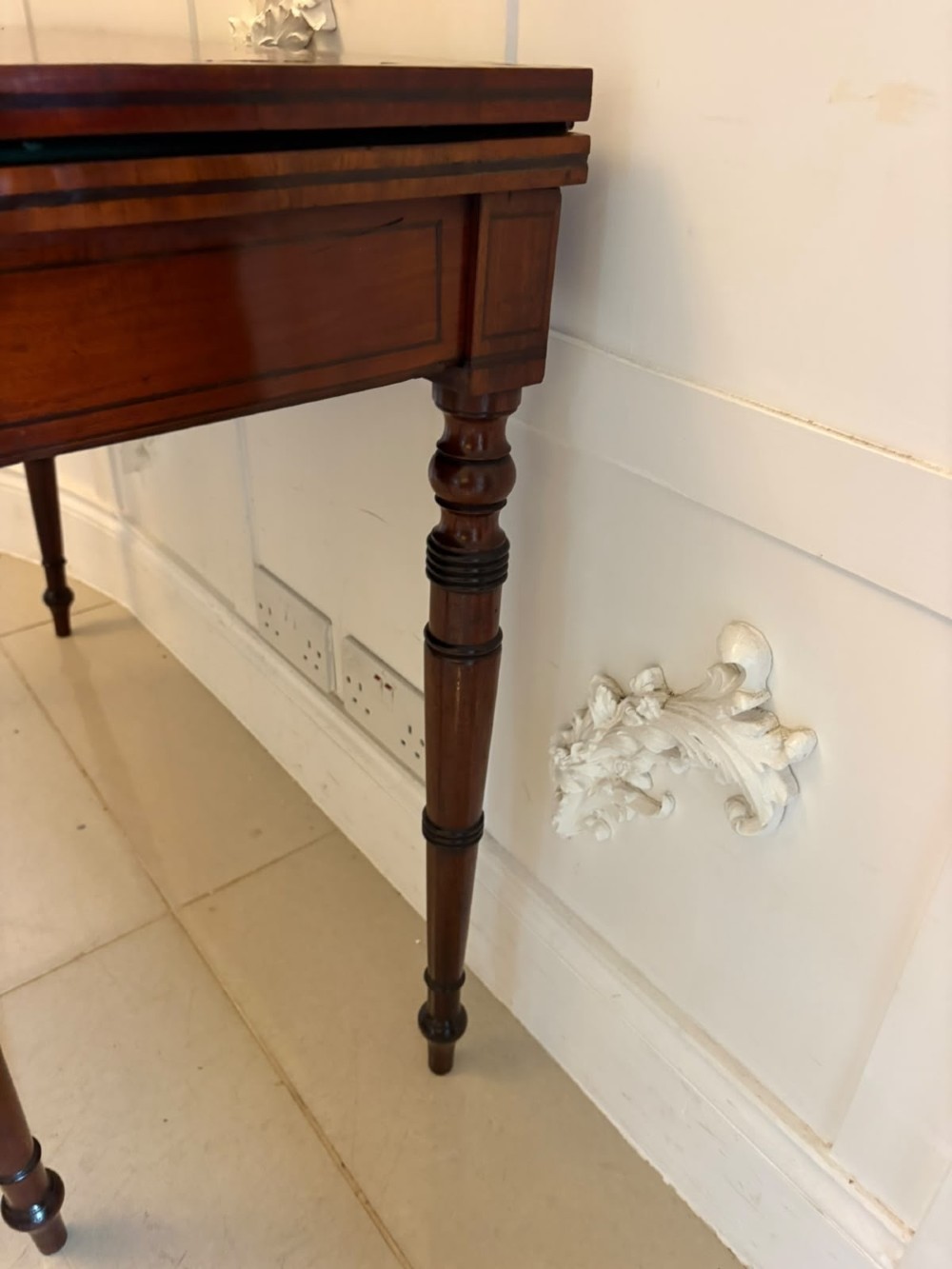 An antique Georgian mahogany fold-over card table featuring turned legs and subtle inlay stringing. View XII