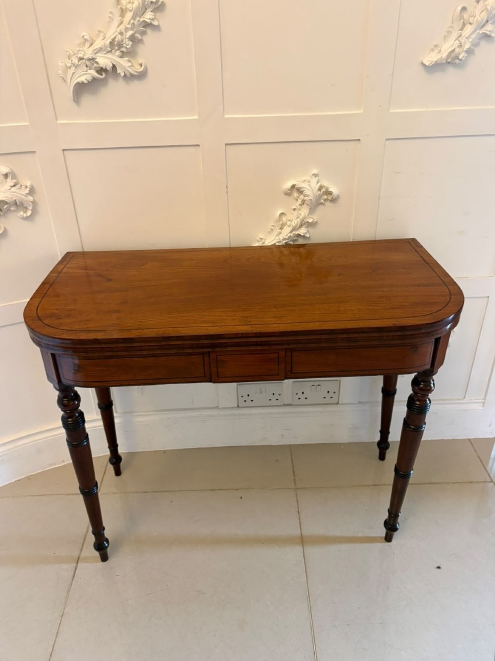 An antique Georgian mahogany fold-over card table featuring turned legs and subtle inlay stringing. View XIII