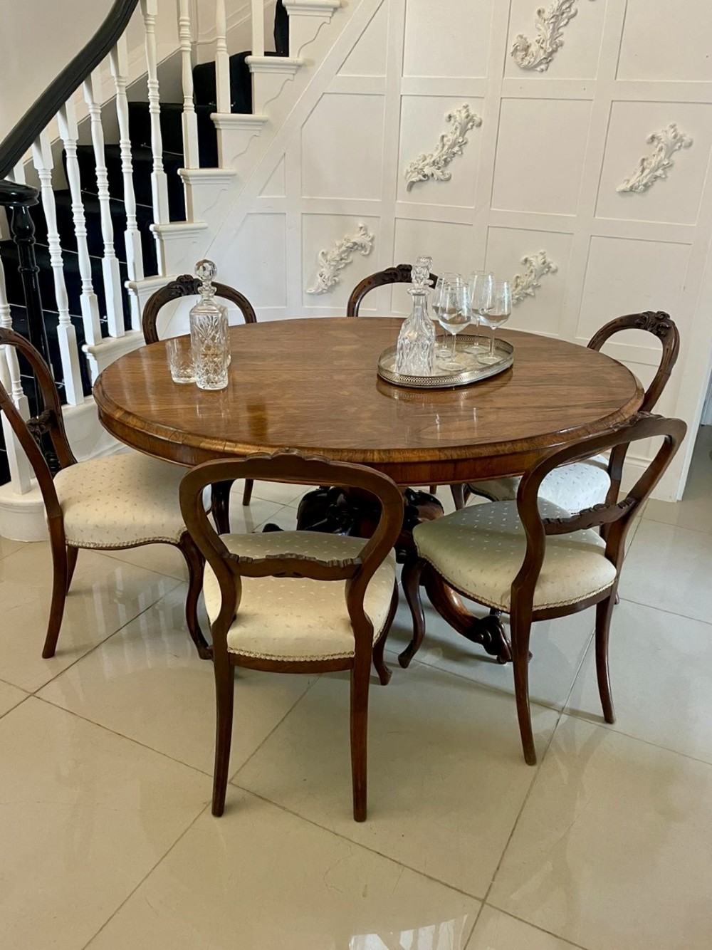 An antique Victorian rosewood tilt-top centre table shown with the circular top tilted vertically on a carved pedestal base. View III