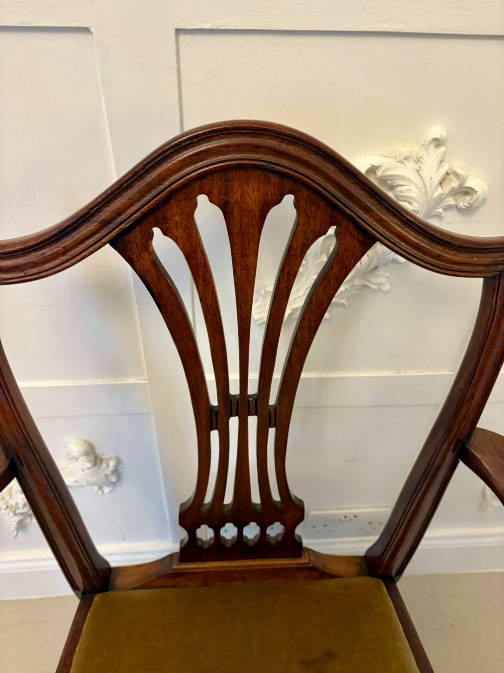 A set of twelve mahogany Hepplewhite style dining chairs featuring shield backs with carved splats and gold velvet drop-in seats. View VII