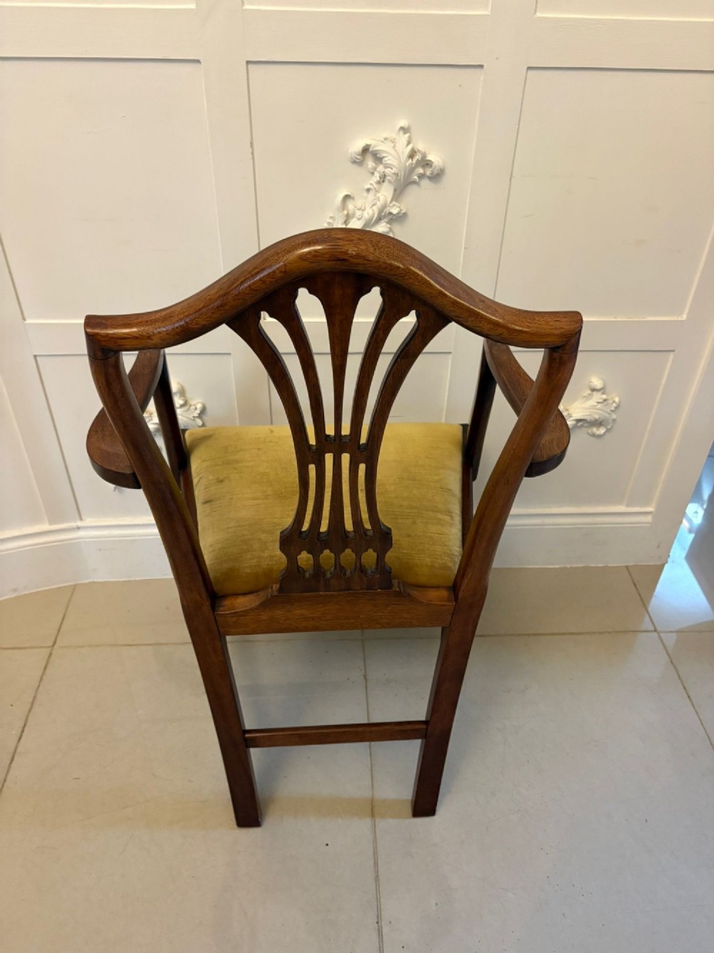 A set of twelve mahogany Hepplewhite style dining chairs featuring shield backs with carved splats and gold velvet drop-in seats. View VIII