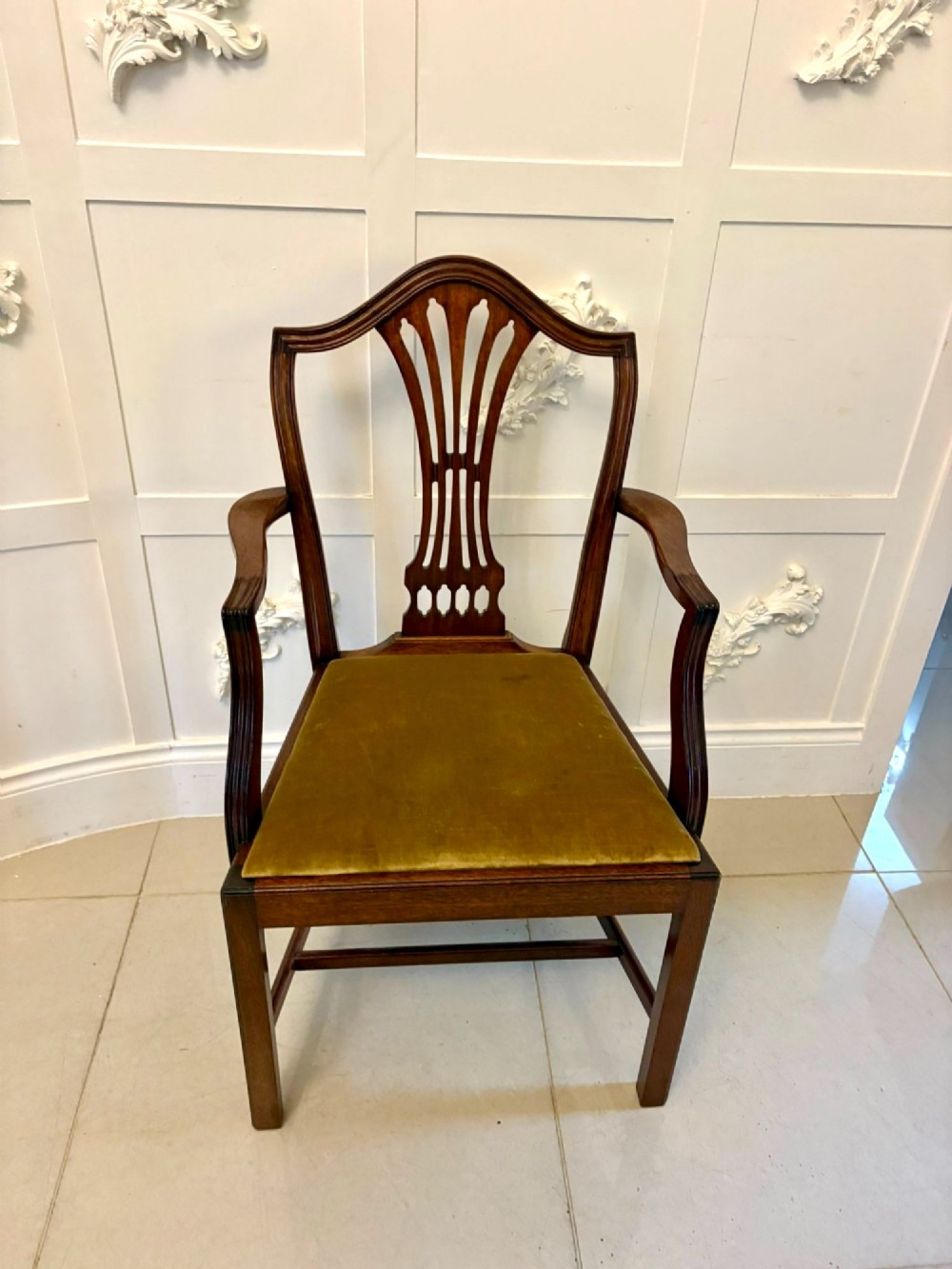 A set of twelve mahogany Hepplewhite style dining chairs featuring shield backs with carved splats and gold velvet drop-in seats. View IX