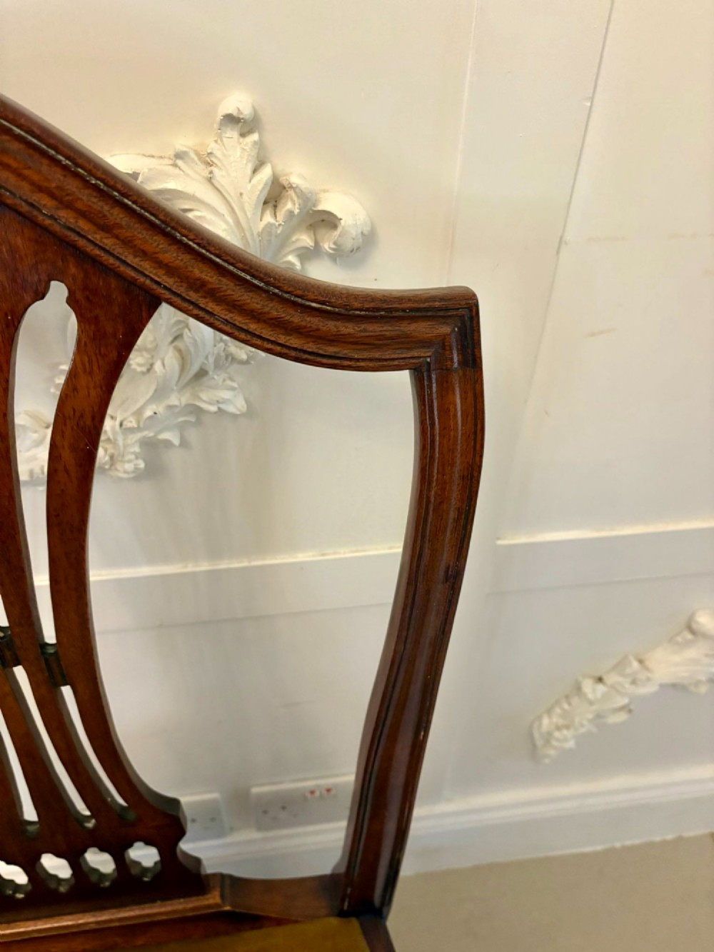 A set of twelve mahogany Hepplewhite style dining chairs featuring shield backs with carved splats and gold velvet drop-in seats. View XIV