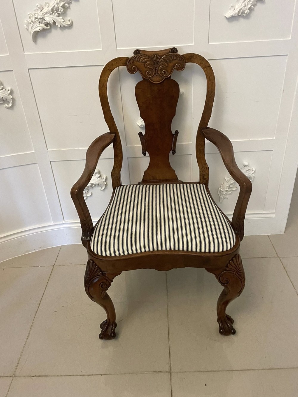 A set of twelve Victorian burr walnut dining chairs with carved splat backs, cabriole legs, and black and white striped upholstered seats. View II
