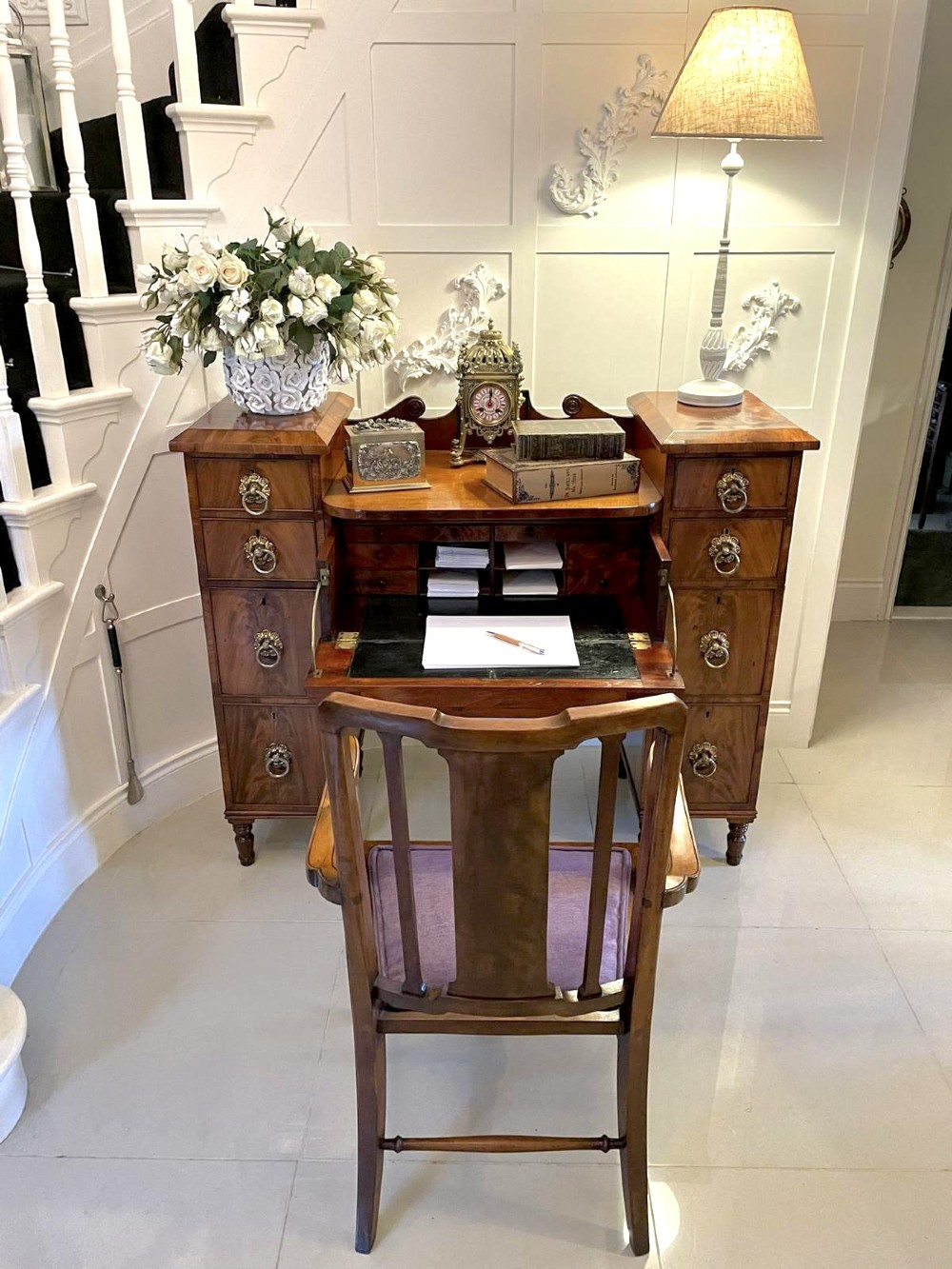 An antique Regency mahogany secretaire sideboard featuring twin pedestals, multiple drawers with brass ring pulls, and a scrolled backboard gallery. View IV