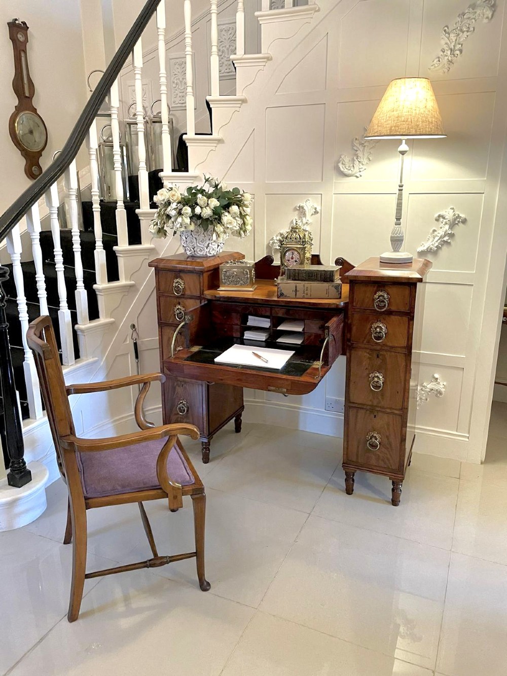 An antique Regency mahogany secretaire sideboard featuring twin pedestals, multiple drawers with brass ring pulls, and a scrolled backboard gallery. View V