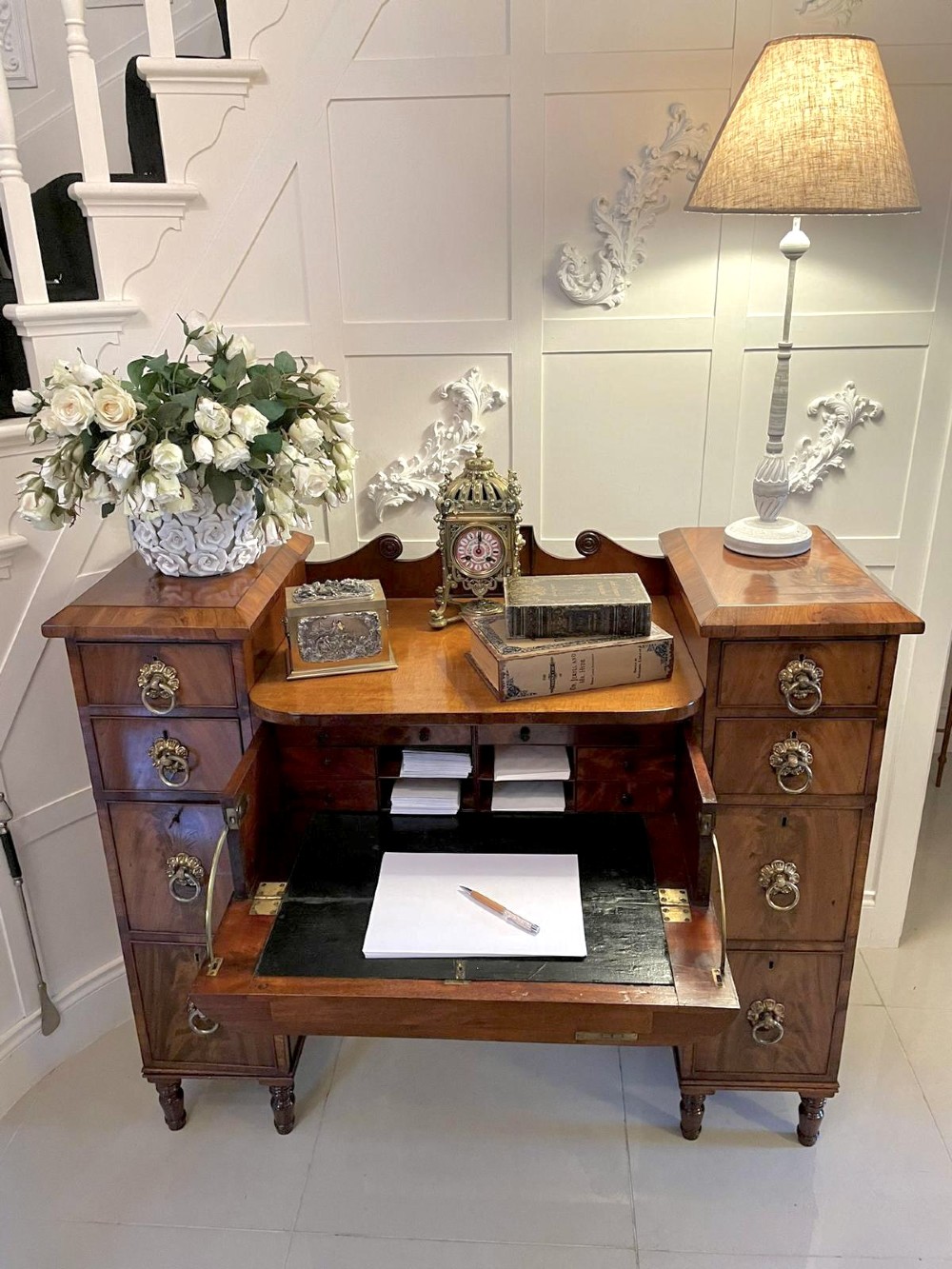 An antique Regency mahogany secretaire sideboard featuring twin pedestals, multiple drawers with brass ring pulls, and a scrolled backboard gallery. View VI