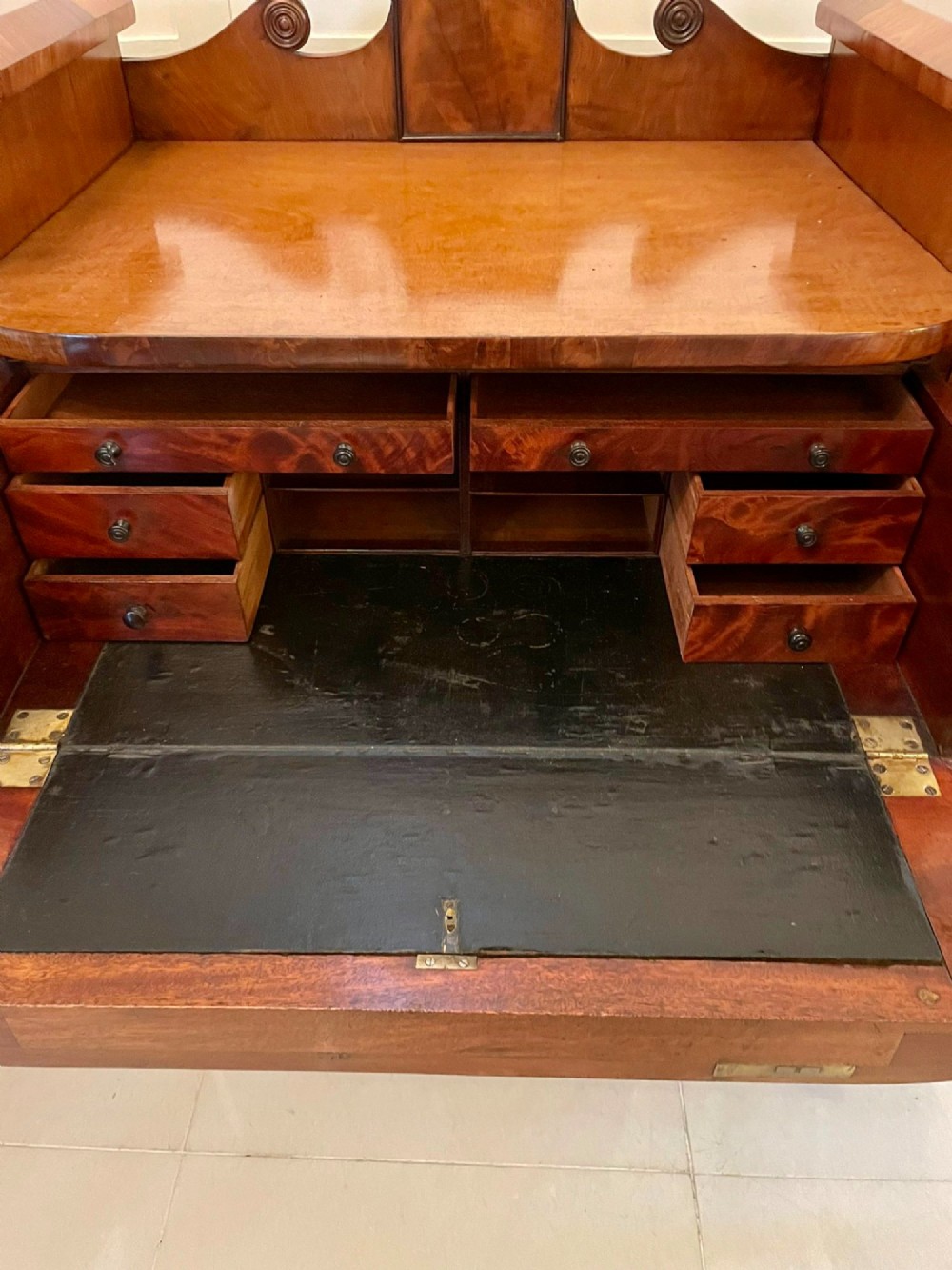 An antique Regency mahogany secretaire sideboard featuring twin pedestals, multiple drawers with brass ring pulls, and a scrolled backboard gallery. View XI