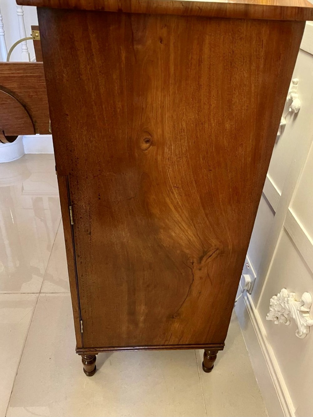 An antique Regency mahogany secretaire sideboard featuring twin pedestals, multiple drawers with brass ring pulls, and a scrolled backboard gallery. View XII