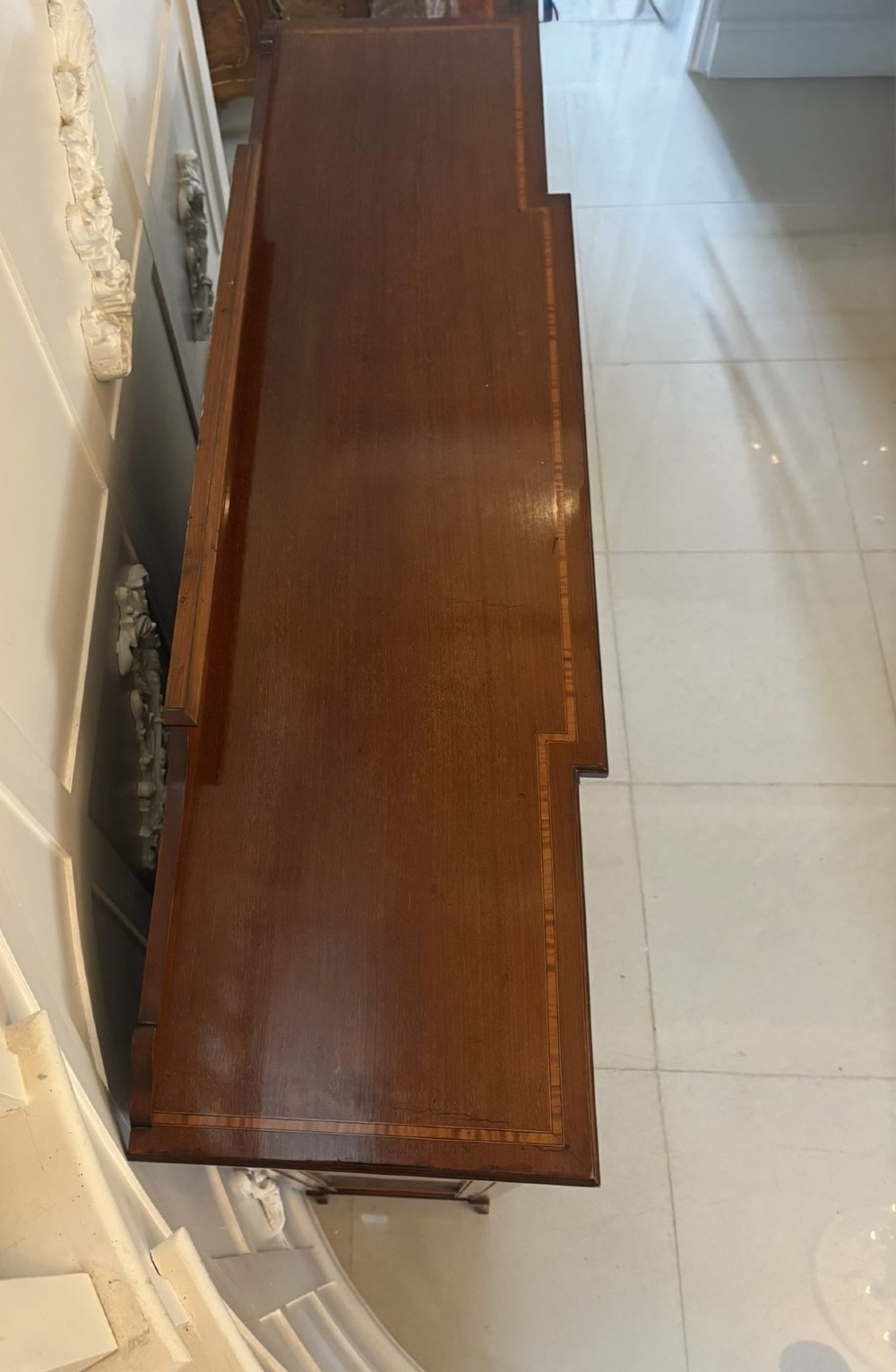 An Edwardian inlaid mahogany display cabinet featuring three glazed doors with decorative glazing bars and a fabric-lined interior. View VII