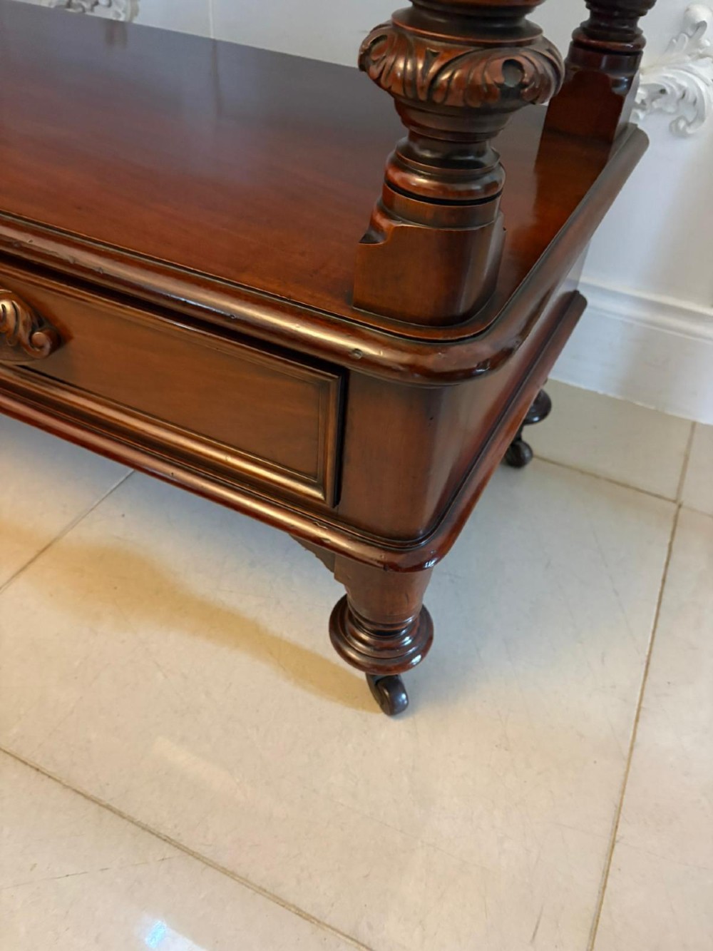 A Victorian mahogany buffet server featuring an openwork carved gallery back, four drawer compartments, turned columns, and an open lower shelf. View VI