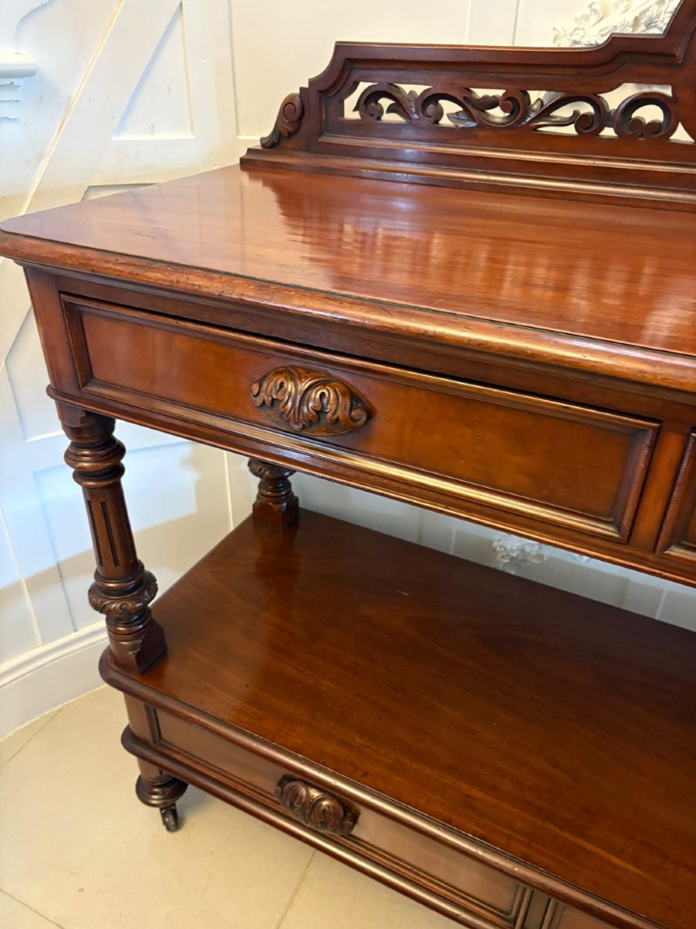 A Victorian mahogany buffet server featuring an openwork carved gallery back, four drawer compartments, turned columns, and an open lower shelf. View XII
