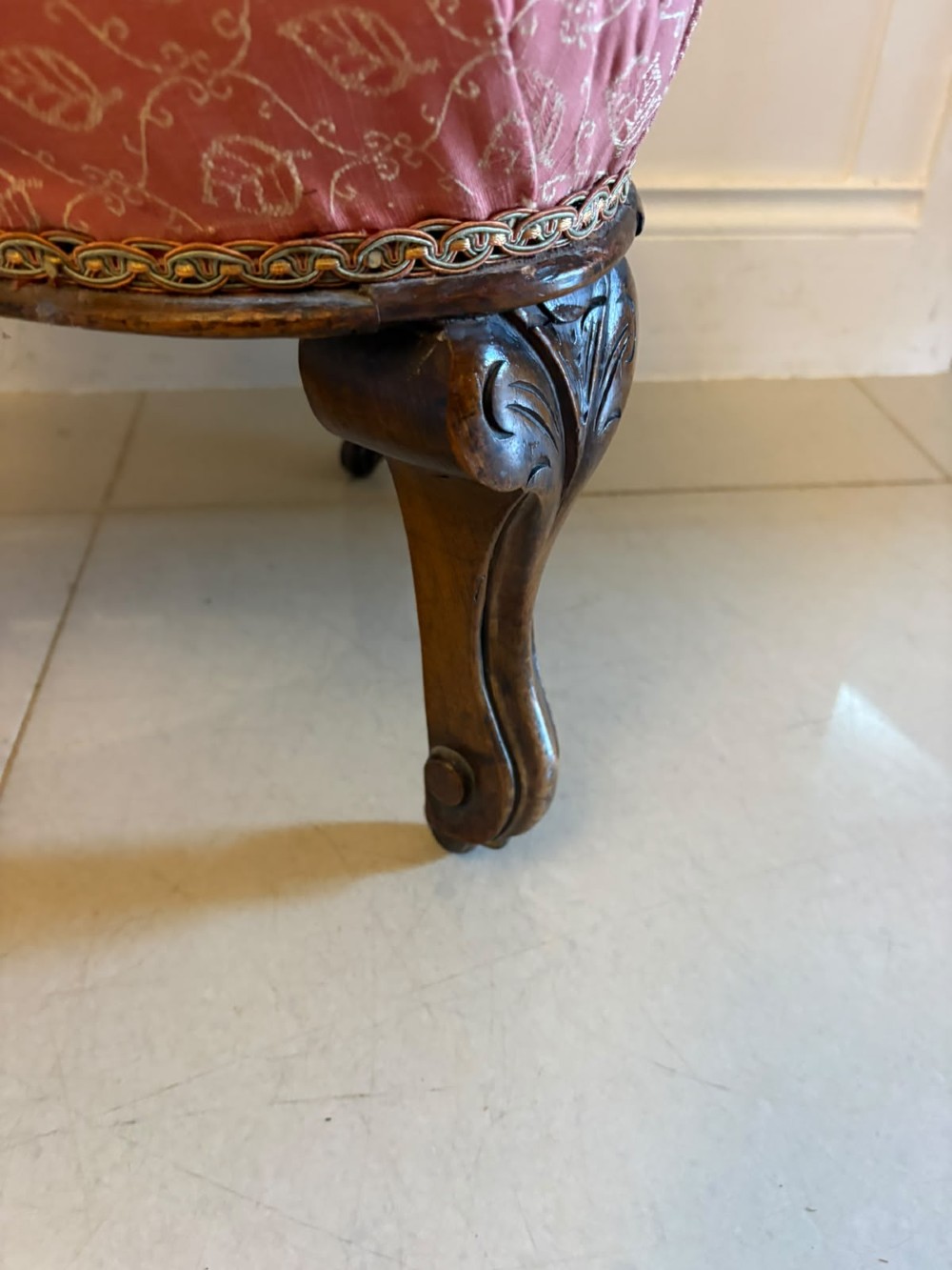 A pair of Victorian carved walnut side chairs with openwork backs and terracotta patterned fabric seats. View V