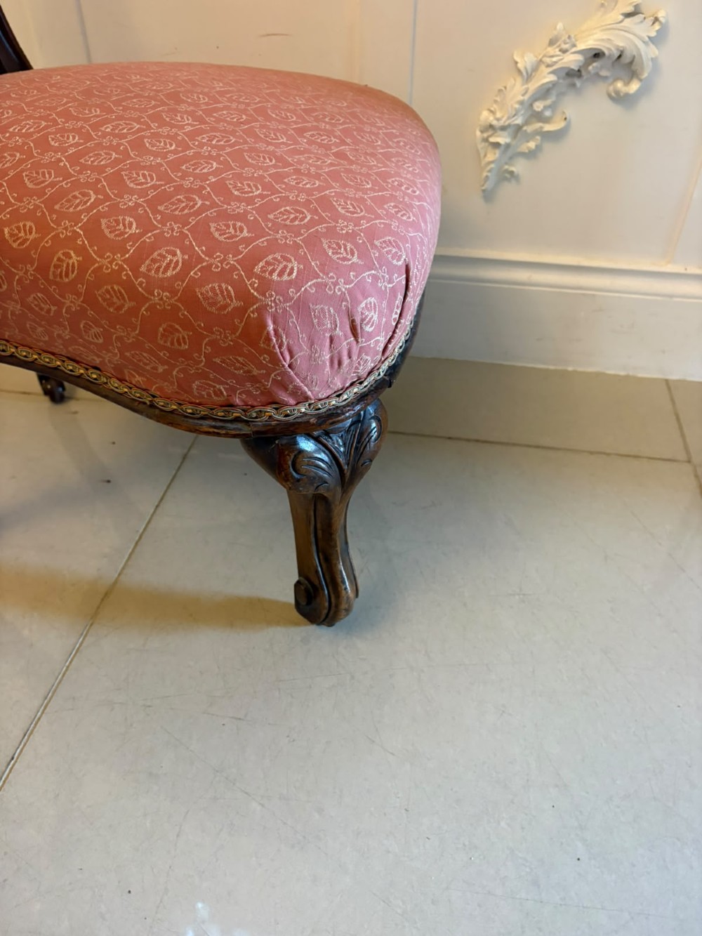 A pair of Victorian carved walnut side chairs with openwork backs and terracotta patterned fabric seats. View VI