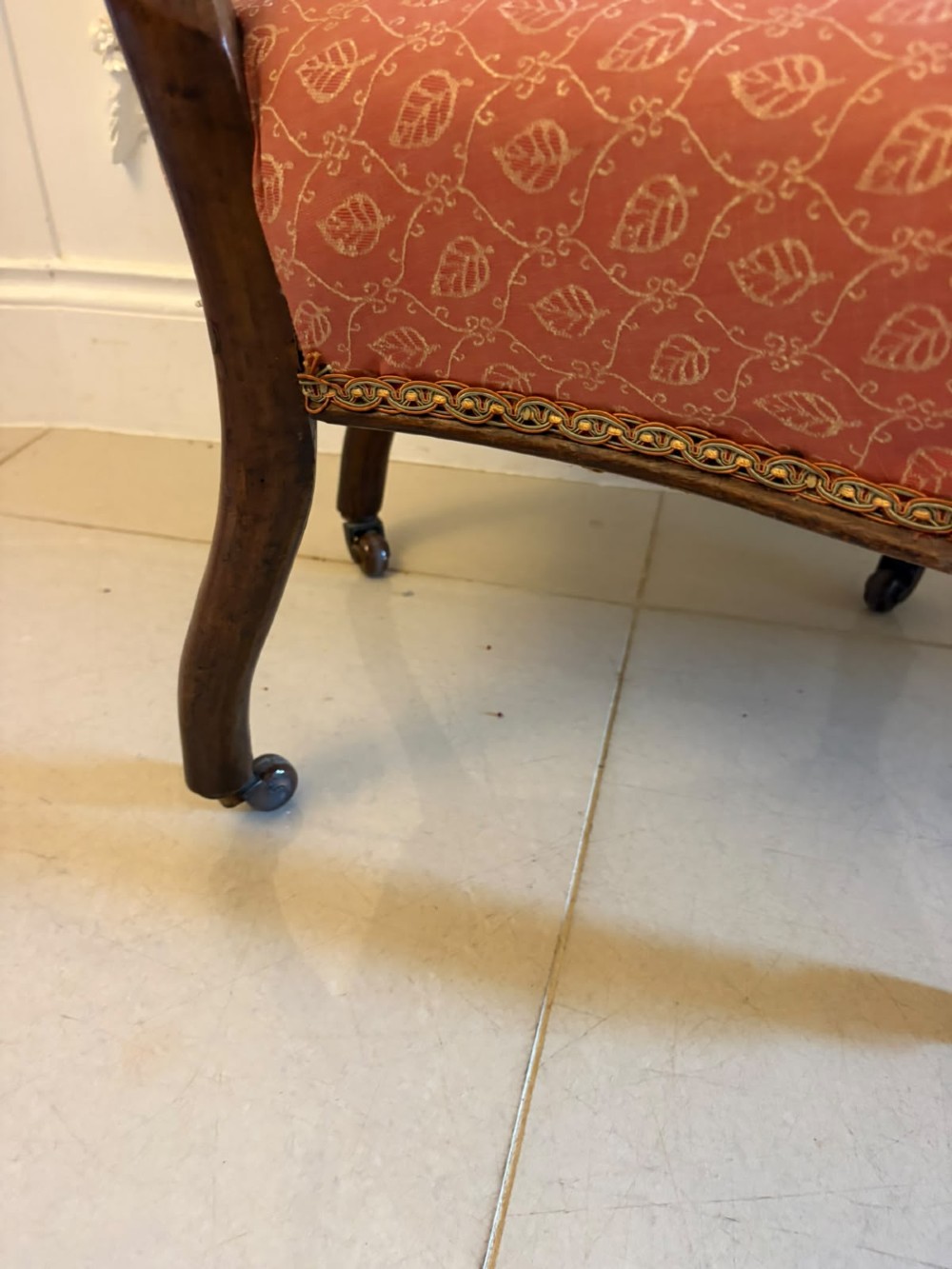 A pair of Victorian carved walnut side chairs with openwork backs and terracotta patterned fabric seats. View VII