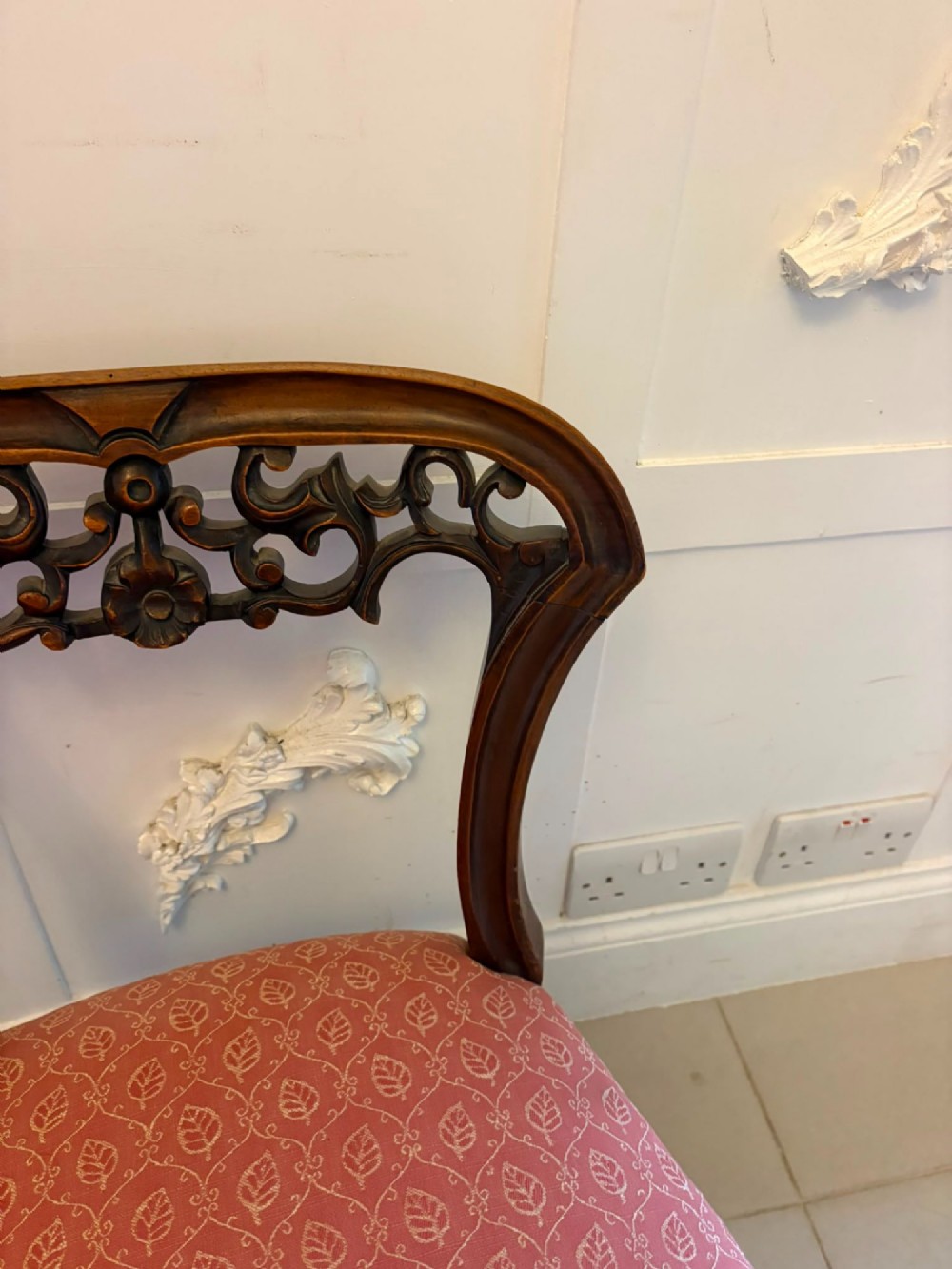 A pair of Victorian carved walnut side chairs with openwork backs and terracotta patterned fabric seats. View IX