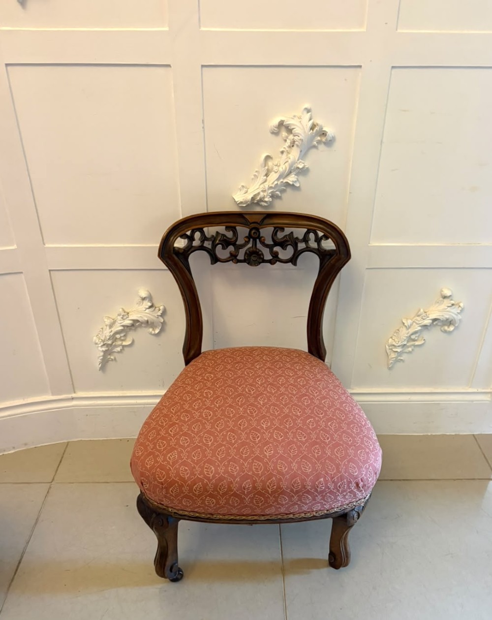 A pair of Victorian carved walnut side chairs with openwork backs and terracotta patterned fabric seats. View XII