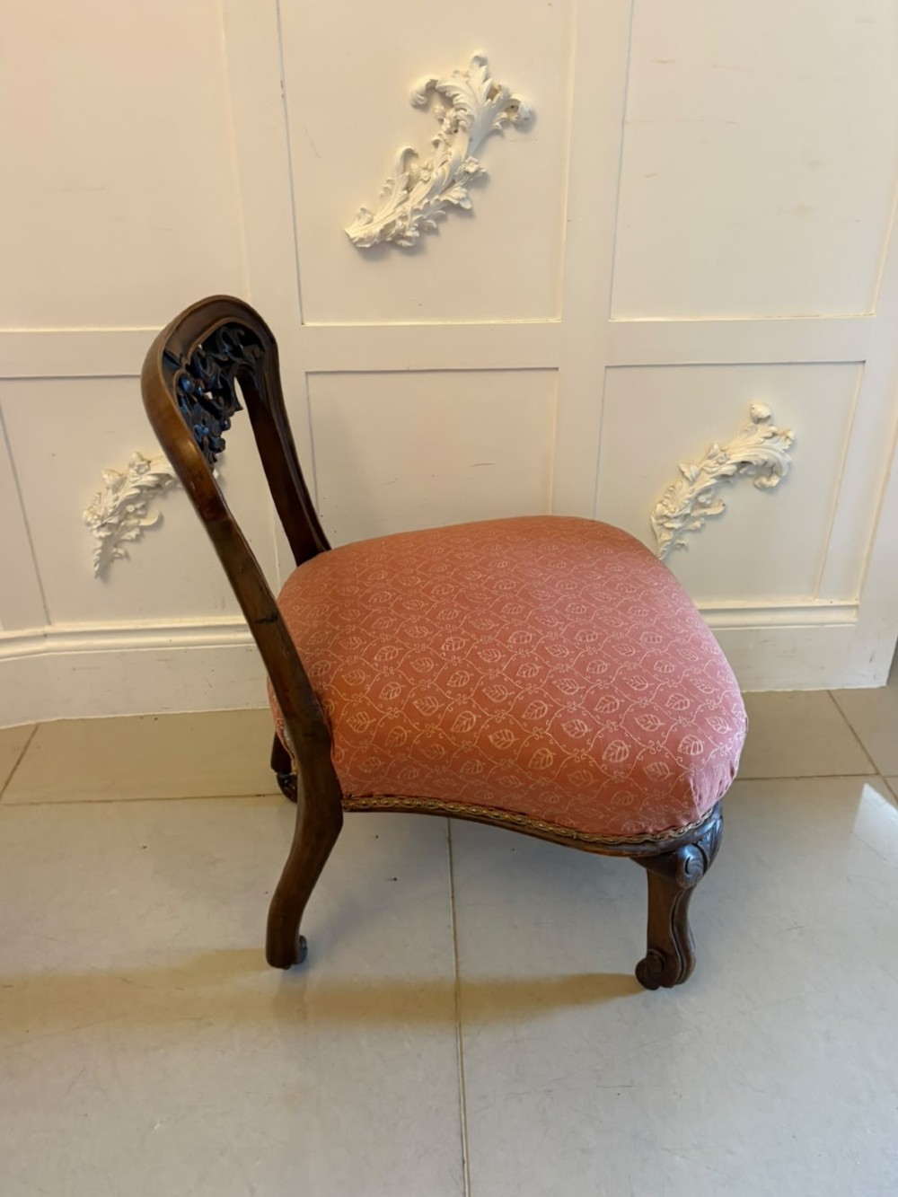 A pair of Victorian carved walnut side chairs with openwork backs and terracotta patterned fabric seats. View XIII
