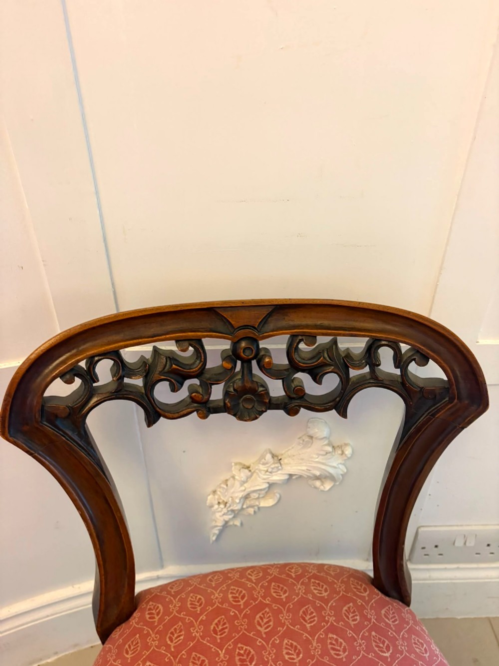 A pair of Victorian carved walnut side chairs with openwork backs and terracotta patterned fabric seats. View XIV