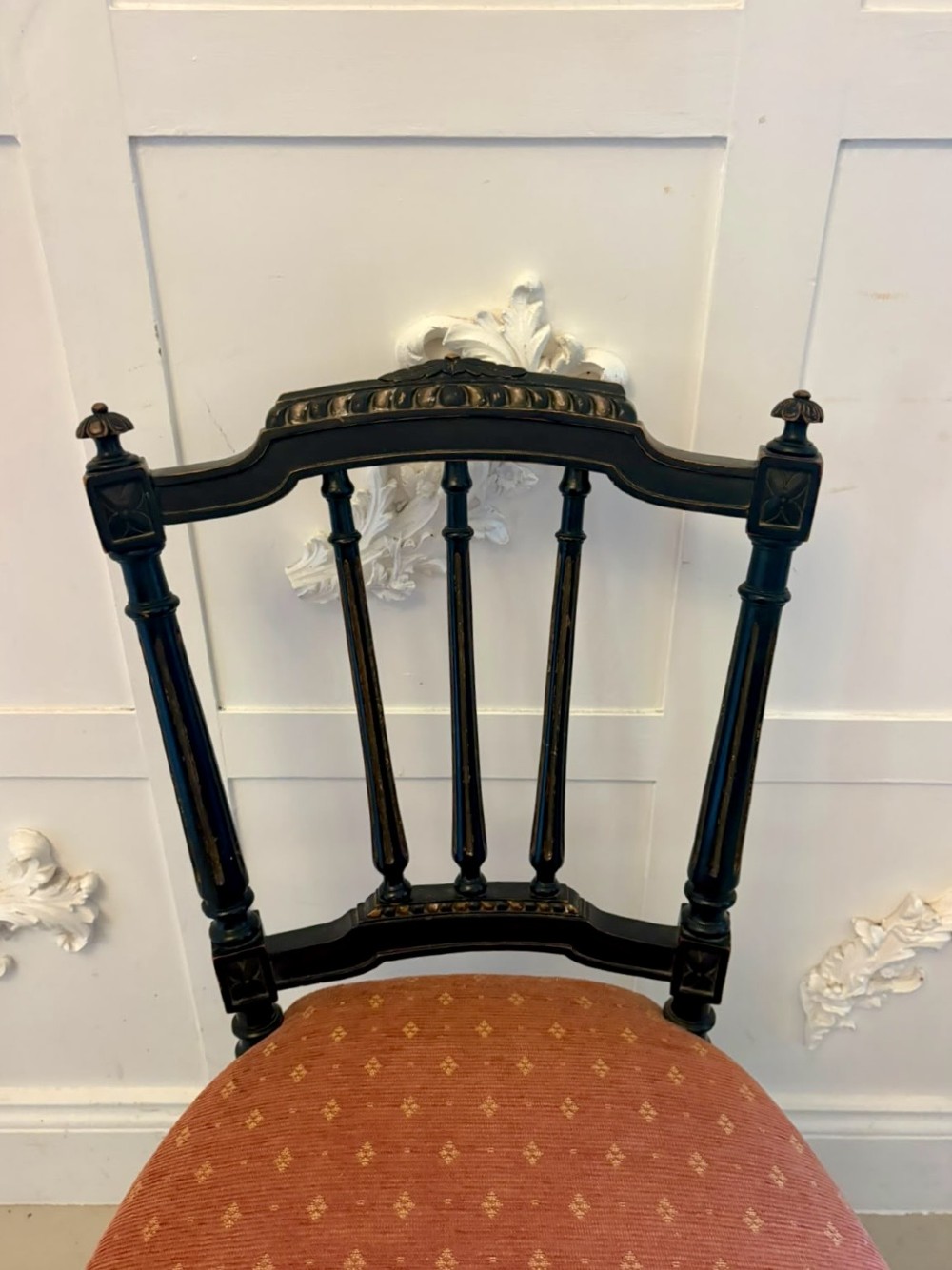 A set of four antique Victorian side chairs featuring ebonised black frames with turned spindle backrests, gilt details, turned front legs, and terracotta patterned upholstered seats. View VIII