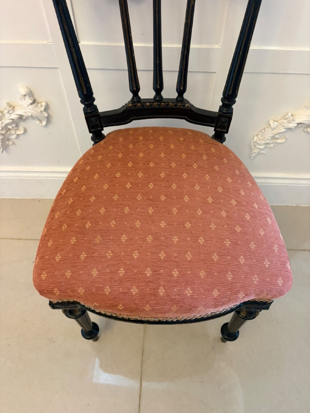 A set of four antique Victorian side chairs featuring ebonised black frames with turned spindle backrests, gilt details, turned front legs, and terracotta patterned upholstered seats. View IX