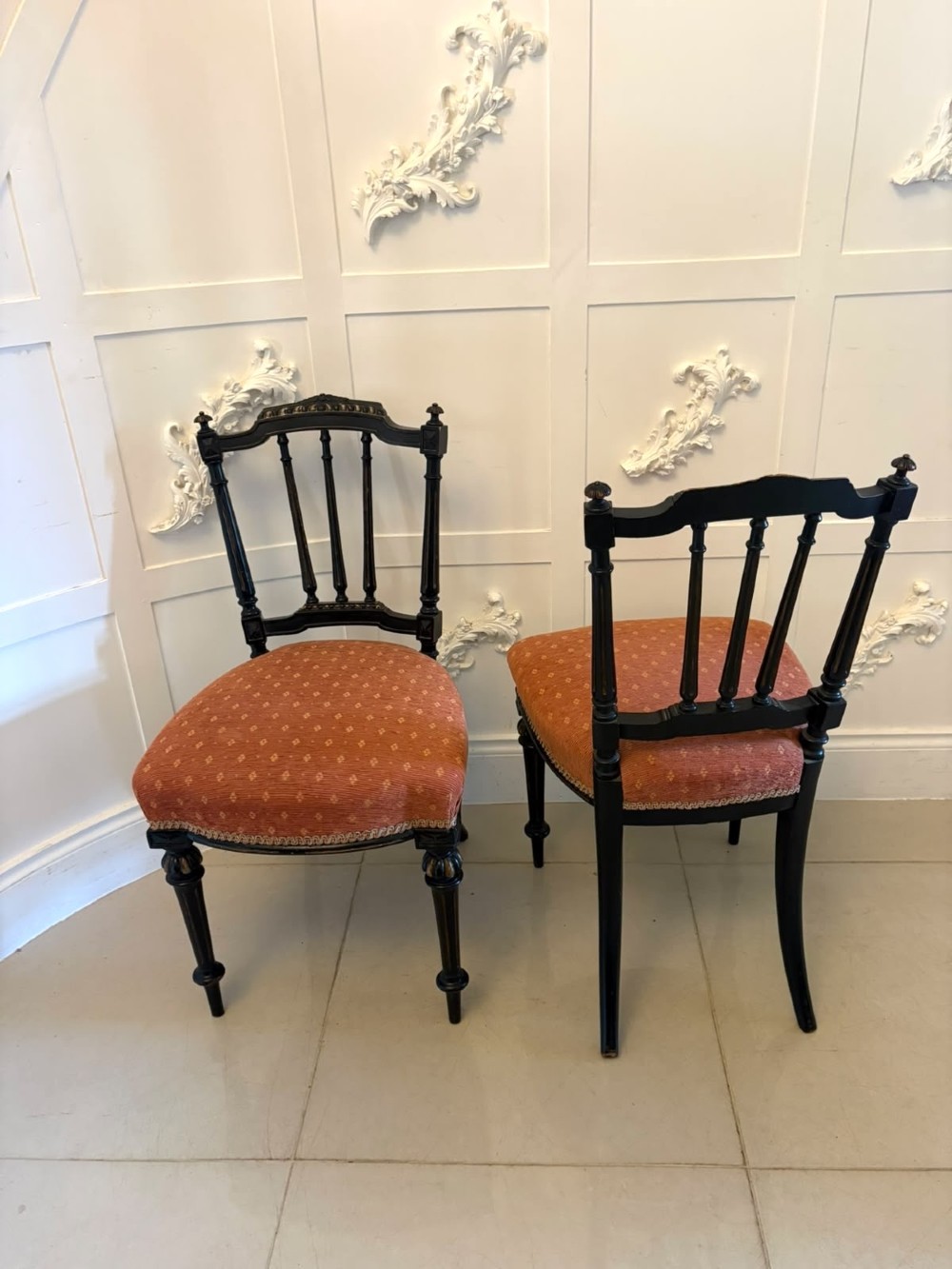 A set of four antique Victorian side chairs featuring ebonised black frames with turned spindle backrests, gilt details, turned front legs, and terracotta patterned upholstered seats. View XIII