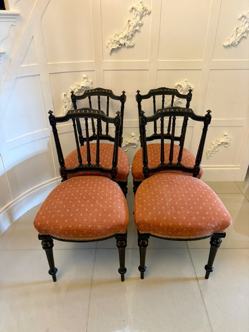 A set of four antique Victorian side chairs featuring ebonised black frames with turned spindle backrests, gilt details, turned front legs, and terracotta patterned upholstered seats. View XIV