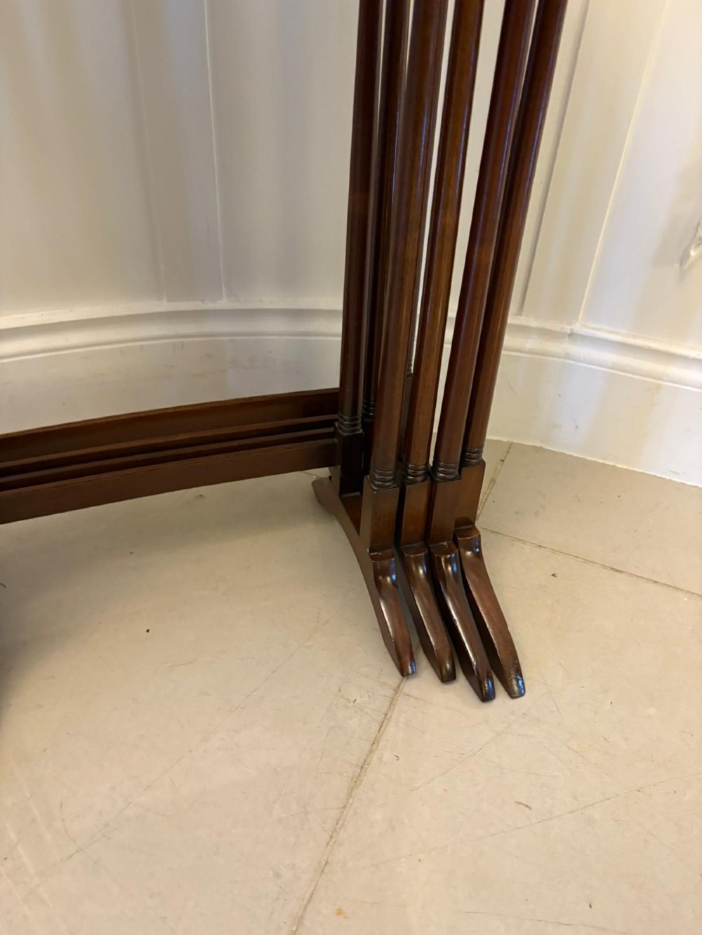 A set of four graduated Edwardian mahogany tables standing stepped outwards to display their inlaid boxwood borders and turned supports. View V