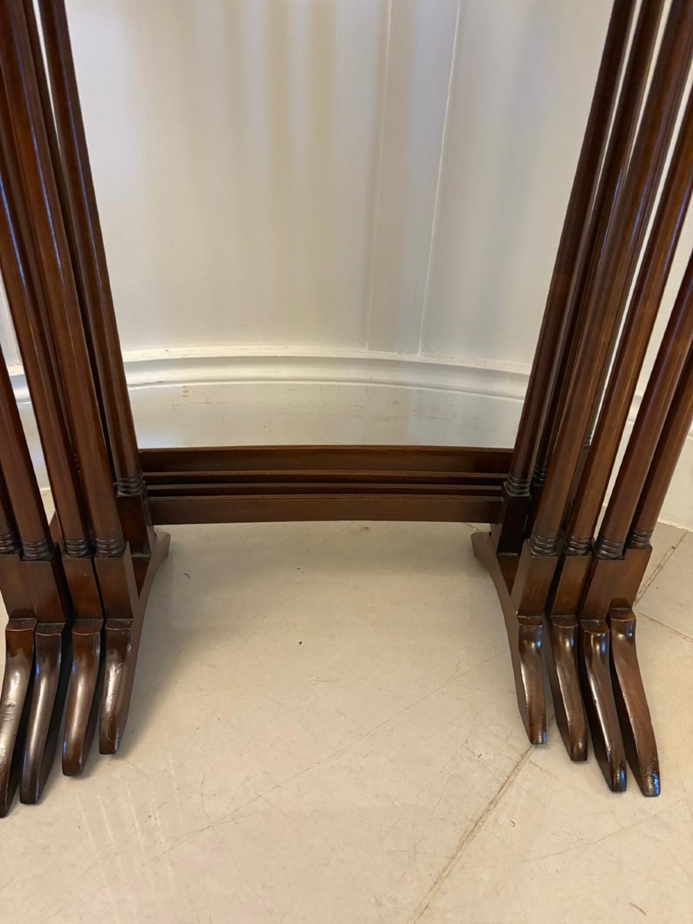 A set of four graduated Edwardian mahogany tables standing stepped outwards to display their inlaid boxwood borders and turned supports. View VI