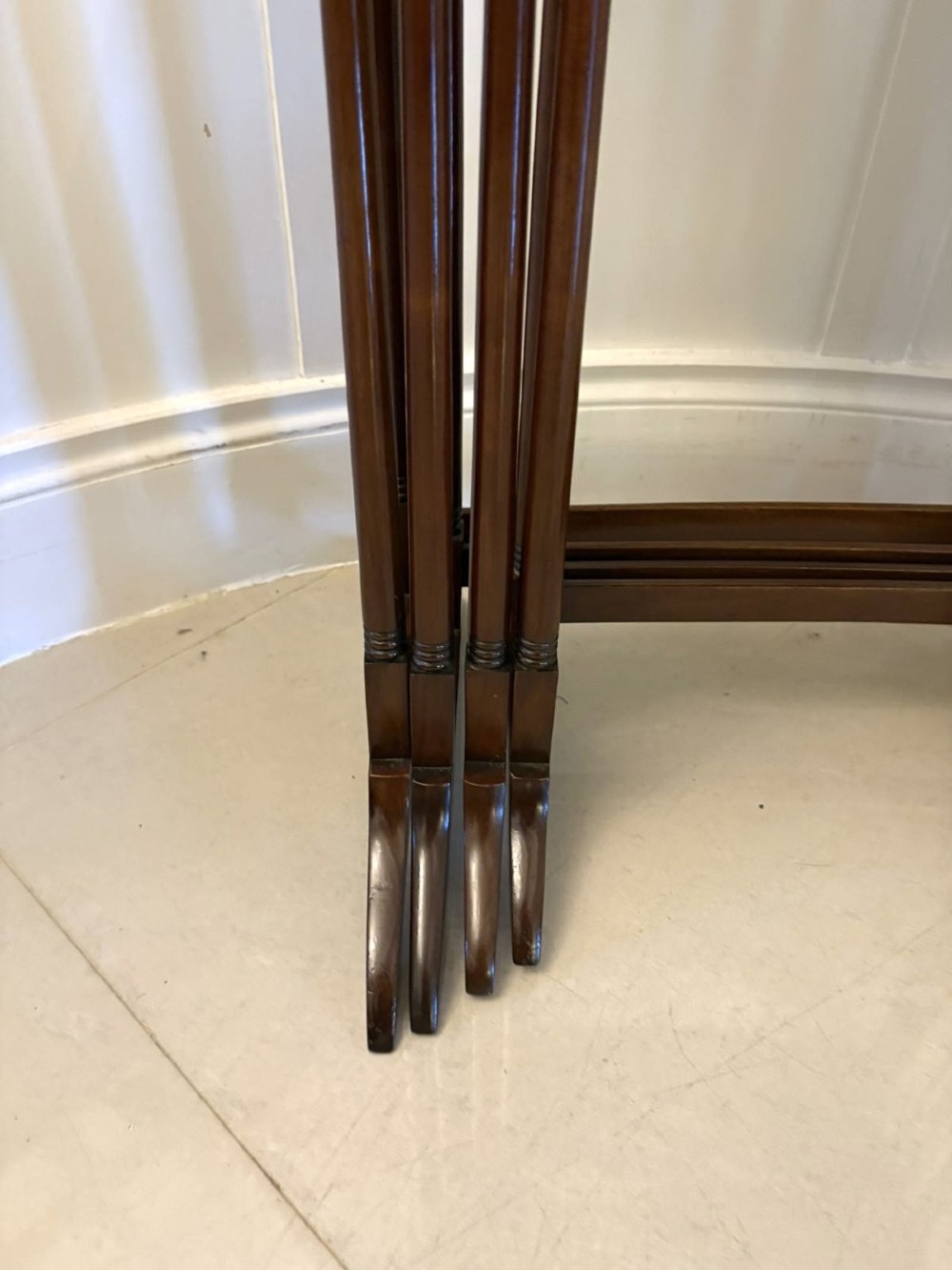 A set of four graduated Edwardian mahogany tables standing stepped outwards to display their inlaid boxwood borders and turned supports. View VII