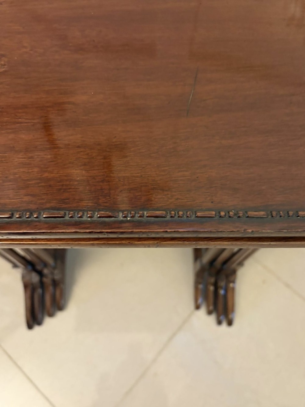 A set of four graduated Edwardian mahogany tables standing stepped outwards to display their inlaid boxwood borders and turned supports. View VIII