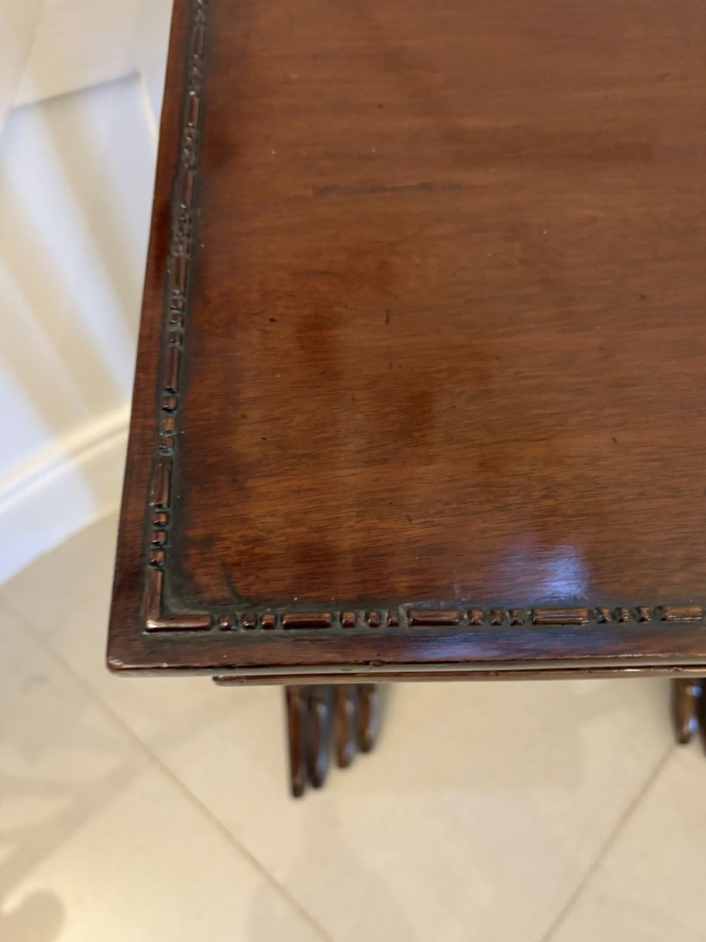 A set of four graduated Edwardian mahogany tables standing stepped outwards to display their inlaid boxwood borders and turned supports. View IX