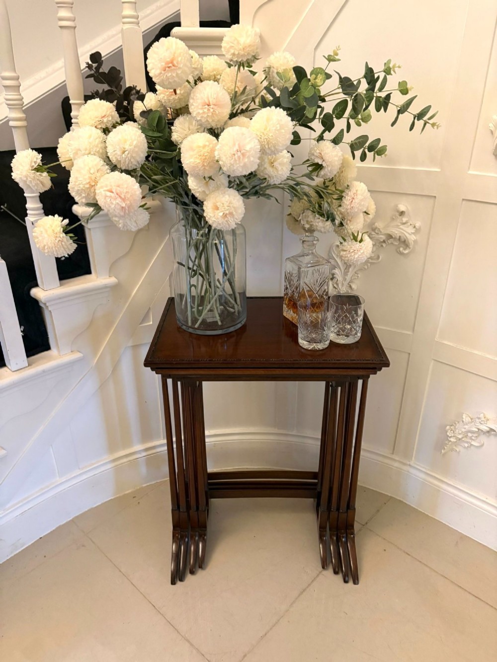 A set of four graduated Edwardian mahogany tables standing stepped outwards to display their inlaid boxwood borders and turned supports. View XII
