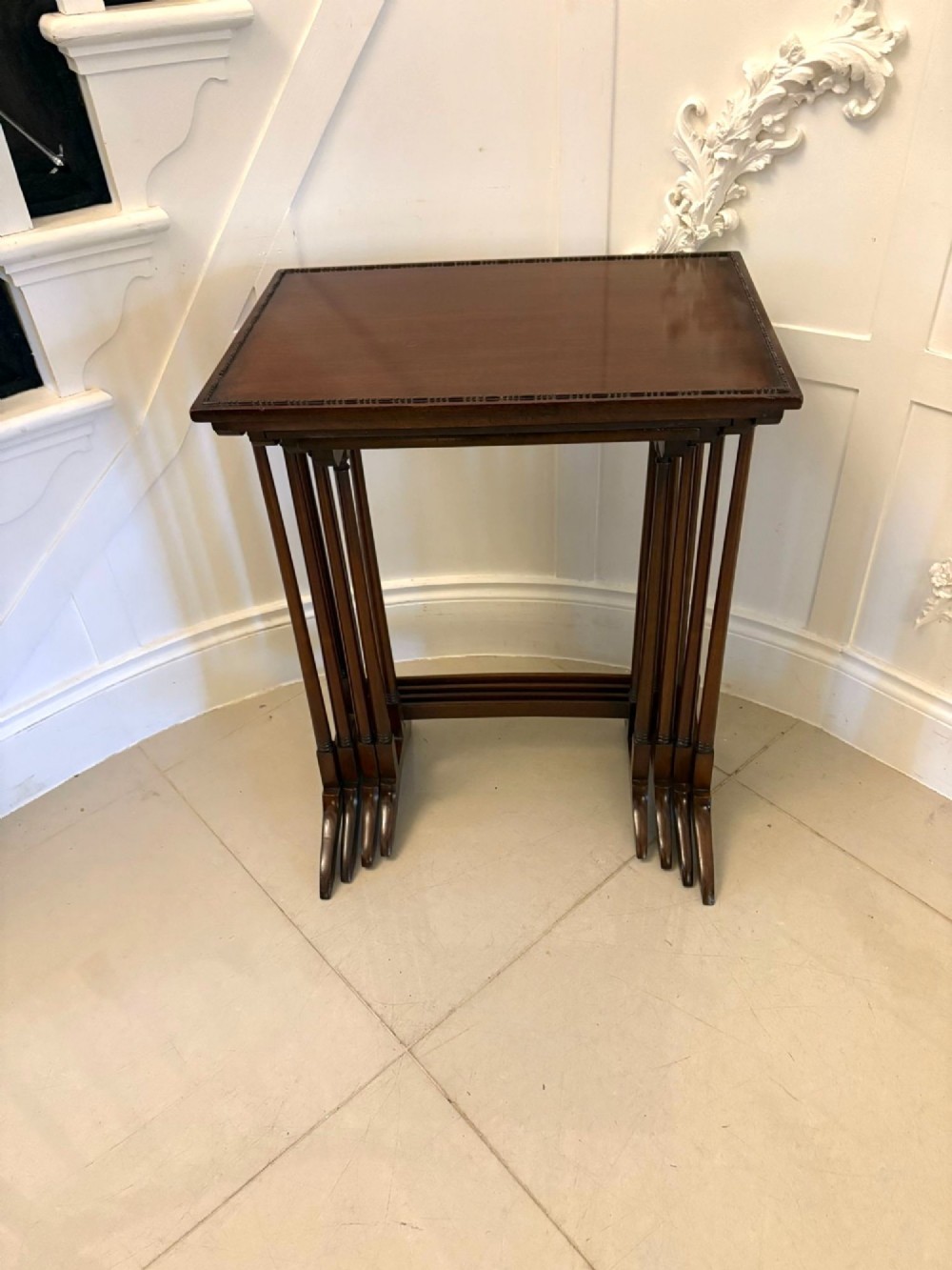 A set of four graduated Edwardian mahogany tables standing stepped outwards to display their inlaid boxwood borders and turned supports. View XIII