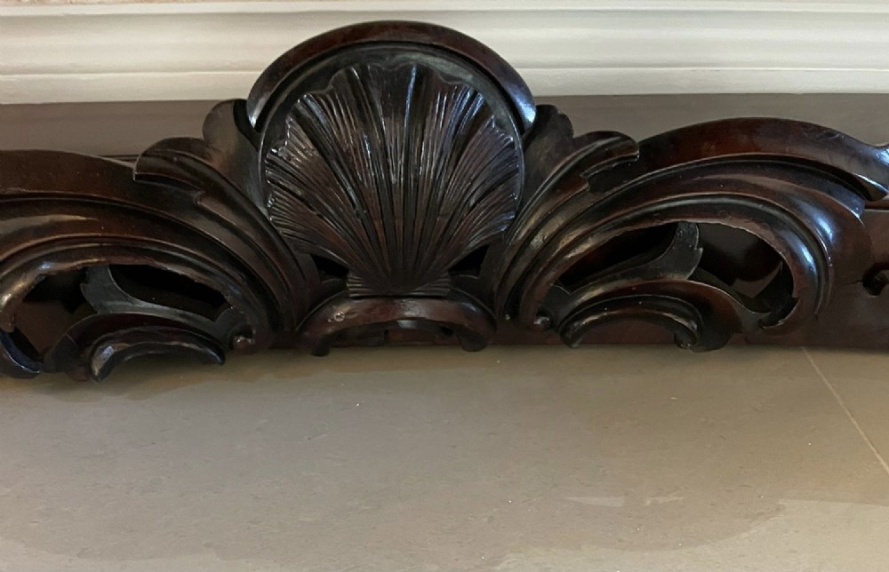 An exceptionally large Victorian dark mahogany console table featuring carved caryatid figures, elaborate scrollwork, a large arched mirror back, and a contoured plinth base. View VI