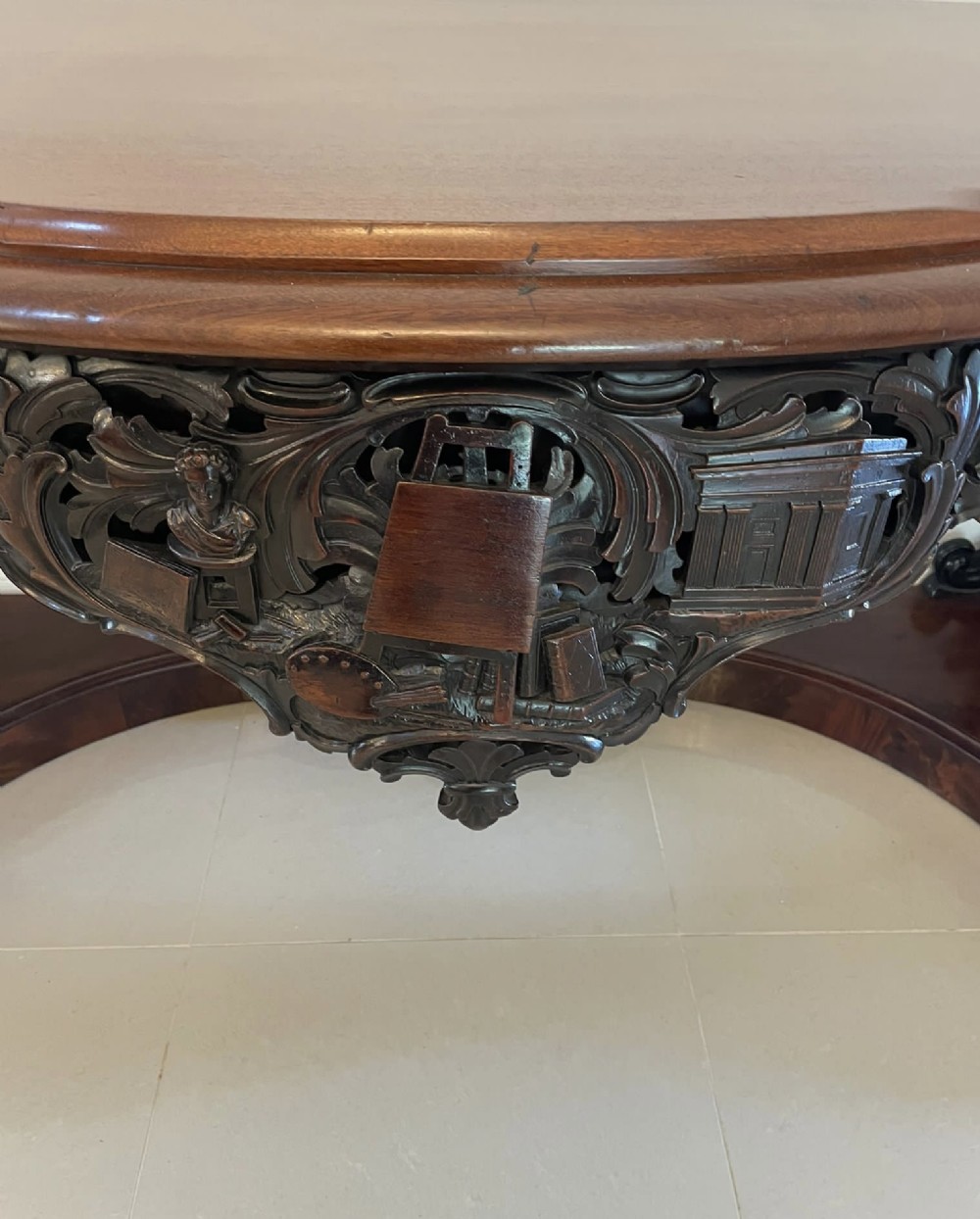 An exceptionally large Victorian dark mahogany console table featuring carved caryatid figures, elaborate scrollwork, a large arched mirror back, and a contoured plinth base. View X
