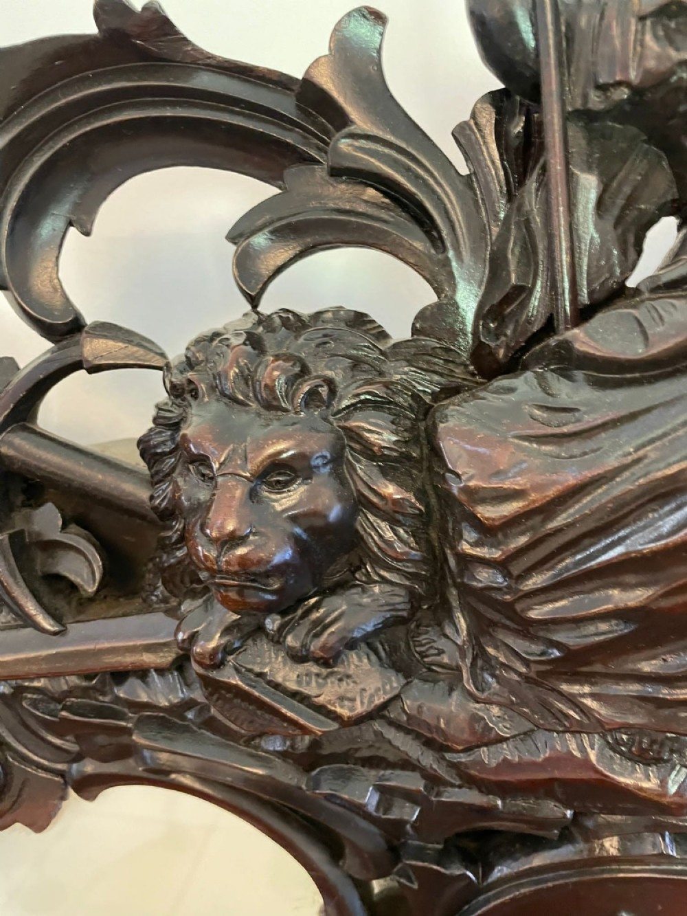 An exceptionally large Victorian dark mahogany console table featuring carved caryatid figures, elaborate scrollwork, a large arched mirror back, and a contoured plinth base. View XII