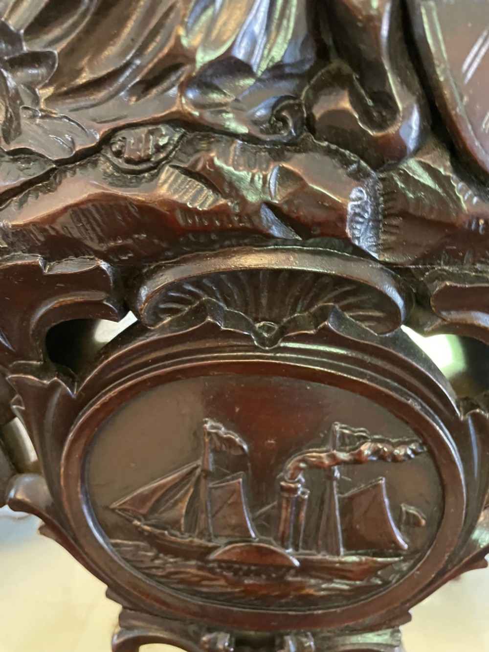 An exceptionally large Victorian dark mahogany console table featuring carved caryatid figures, elaborate scrollwork, a large arched mirror back, and a contoured plinth base. View XV