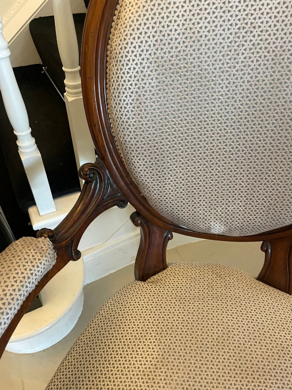 A Victorian carved walnut cameo back sofa featuring three oval upholstered panels, floral crestings, and cabriole legs on castors. View III