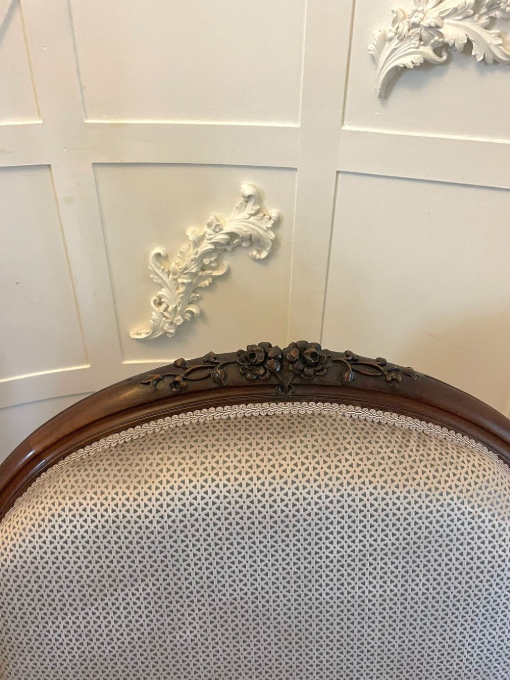 A Victorian carved walnut cameo back sofa featuring three oval upholstered panels, floral crestings, and cabriole legs on castors. View IV