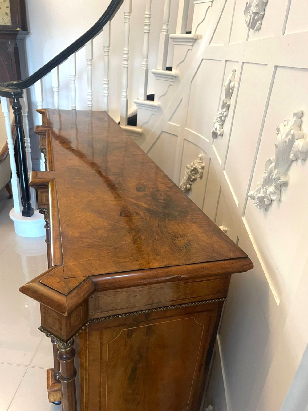 A Victorian burr walnut credenza featuring a central marquetry inlaid timber door flanked by two glazed side cabinets and turned column supports. View IX