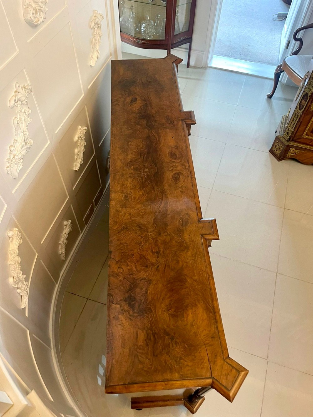 A Victorian burr walnut credenza featuring a central marquetry inlaid timber door flanked by two glazed side cabinets and turned column supports. View X