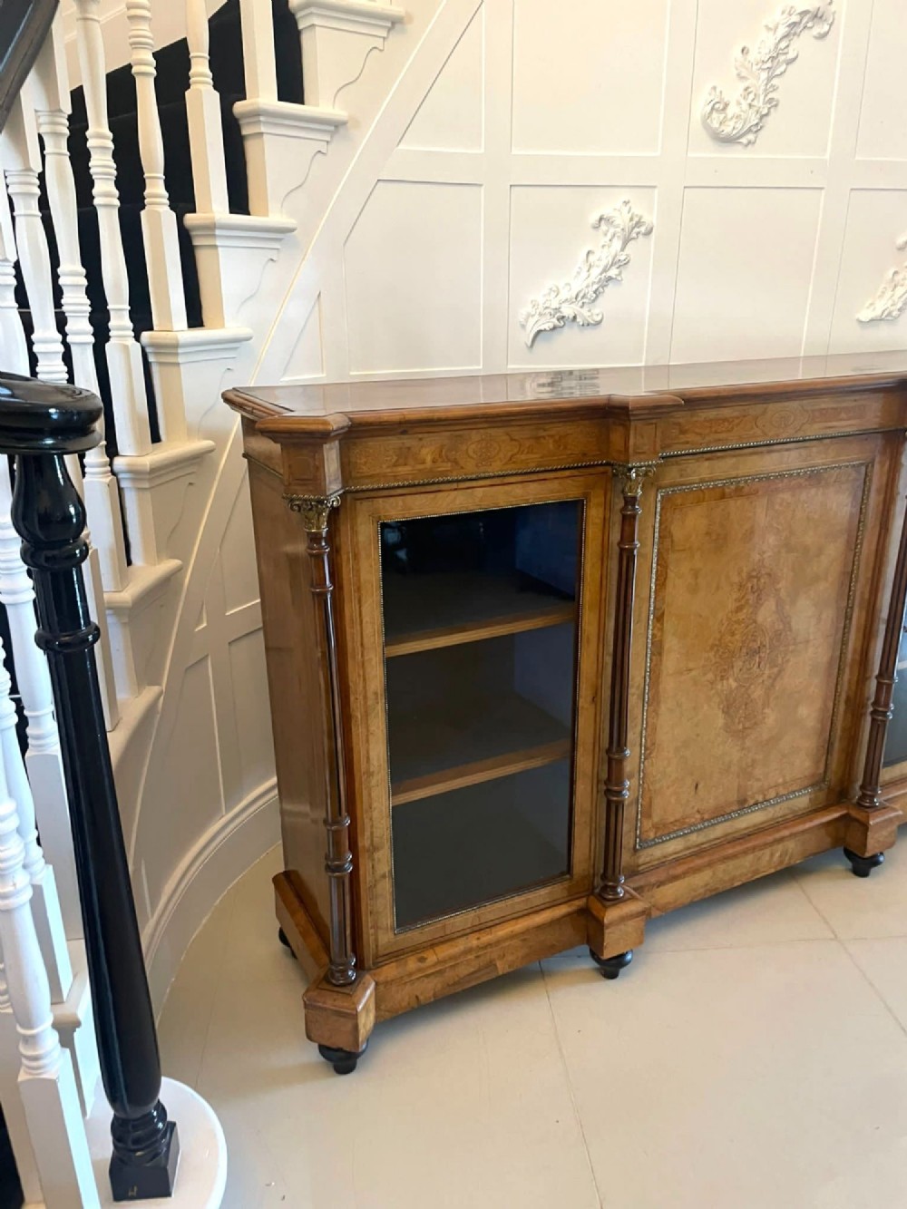 A Victorian burr walnut credenza featuring a central marquetry inlaid timber door flanked by two glazed side cabinets and turned column supports. View XIII