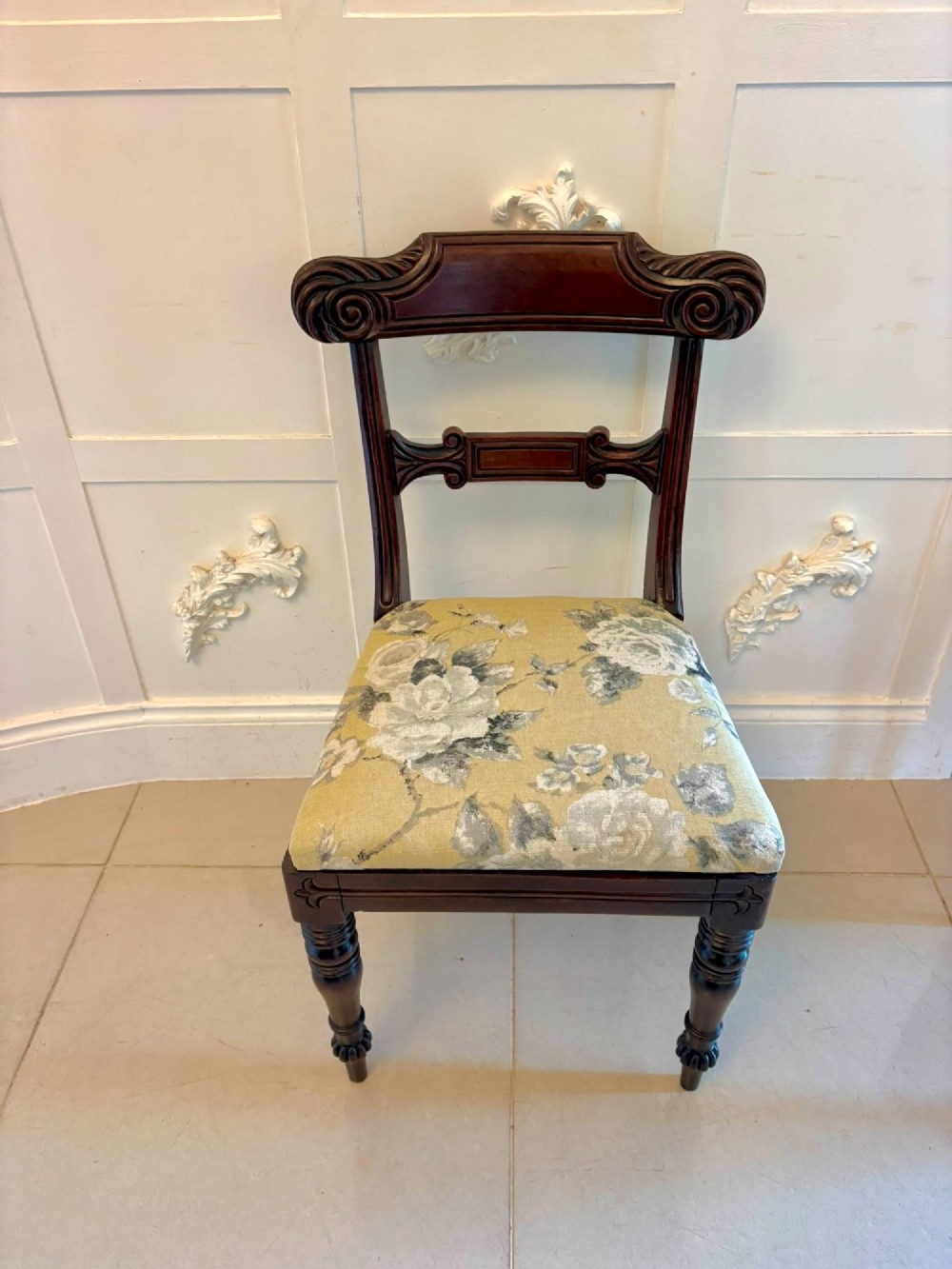 A set of eight Regency mahogany dining chairs comprising six side chairs and two carver armchairs with scroll-carved top rails and turned front legs. View V