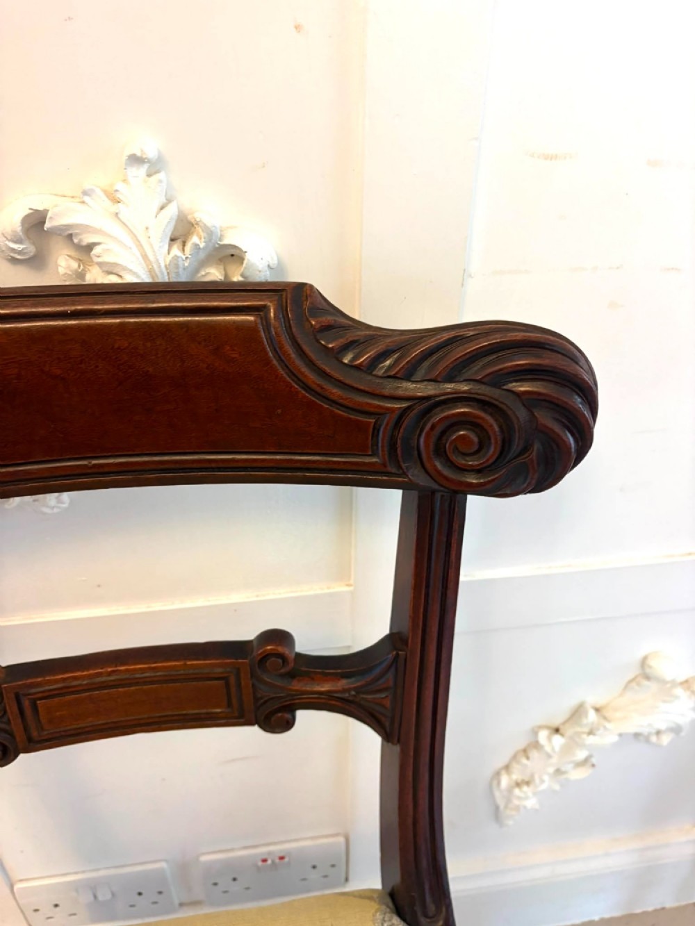 A set of eight Regency mahogany dining chairs comprising six side chairs and two carver armchairs with scroll-carved top rails and turned front legs. View VIII