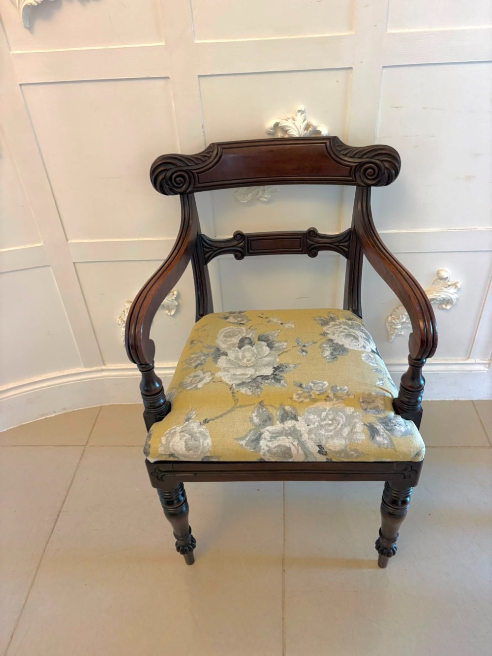 A set of eight Regency mahogany dining chairs comprising six side chairs and two carver armchairs with scroll-carved top rails and turned front legs. View XII