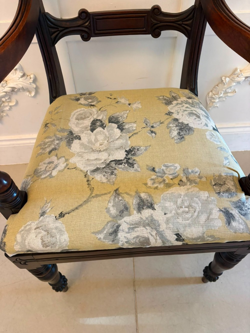 A set of eight Regency mahogany dining chairs comprising six side chairs and two carver armchairs with scroll-carved top rails and turned front legs. View XIV