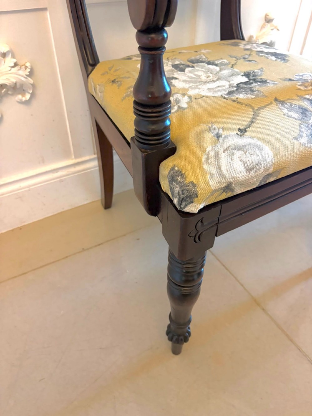 A set of eight Regency mahogany dining chairs comprising six side chairs and two carver armchairs with scroll-carved top rails and turned front legs. View XV